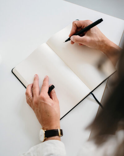 Business Woman writing down in a notebook