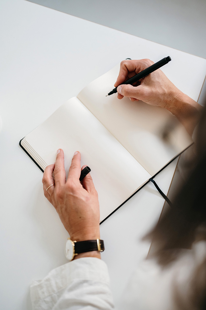 Business Woman writing down in a notebook